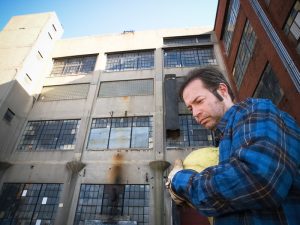 A depressed factory worker and shuttered plant.