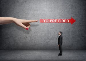 Big female arm pointing at red arrow with 'you're fired words' over small businessman. Boss and subordinate. Unemployment. Losing a job.