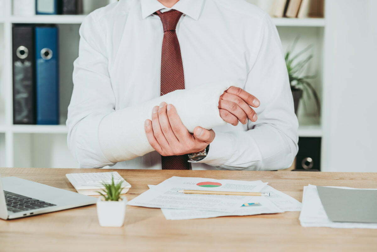 How to Get Workers Compensation in North Carolina 1 cropped view of worker holding broken arm wile sit 2021 10 07 21 46 05 utc