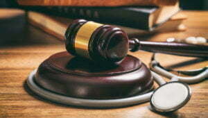 judge gavel and a stethoscope on a wooden desk 2021 08 26 16 34 03 utc