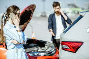 Drivers standing beside their vehicles after a car accident