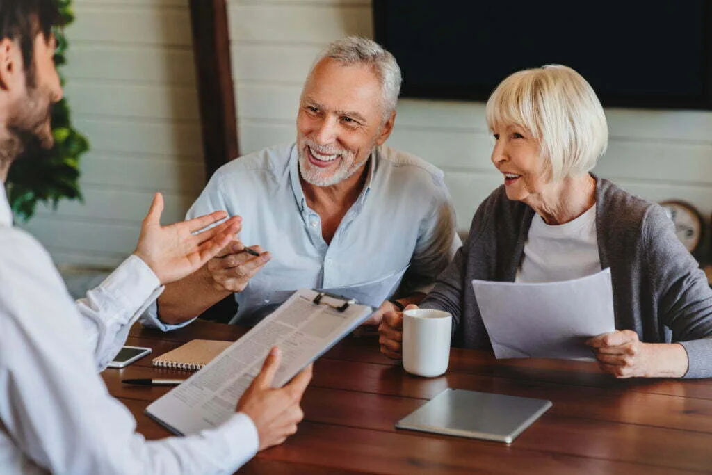 What Should I Say to the Insurance Adjuster After My Accident? 2 happy aged couple consulting with insurance agent 2022 06 21 17 44 33 utc