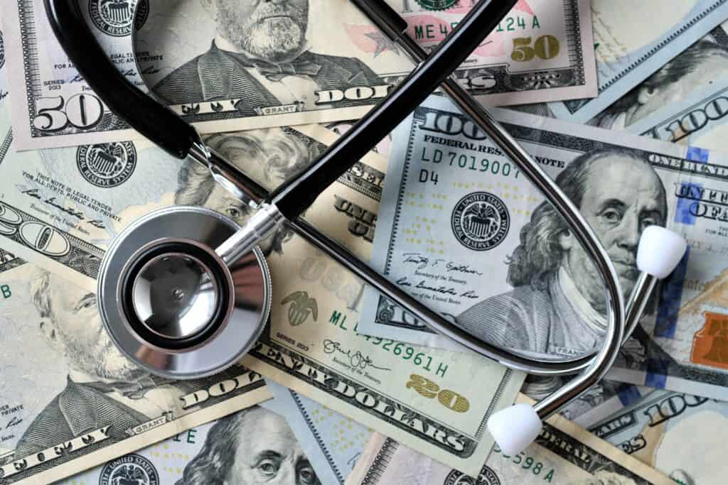 stethoscope laying on money medical costs docto 2022 08 01 04 12 39 utc
