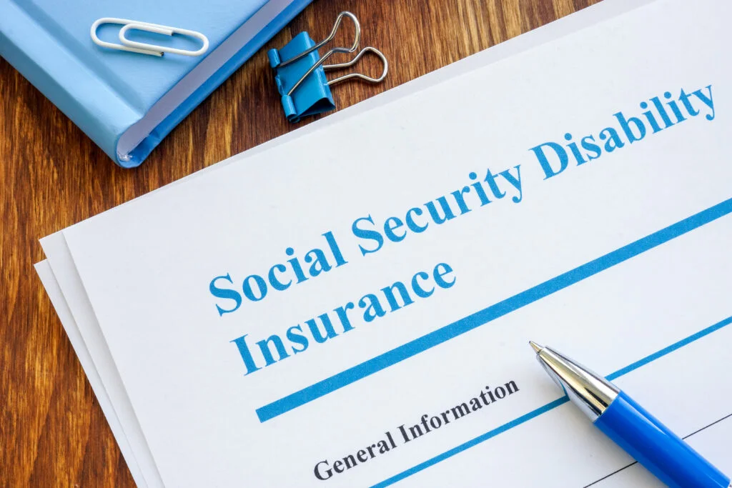 What's the Difference between Supplemental Security Income and Social Security Disability? 2 40104836 social security disability insurance ssdi application form and pen