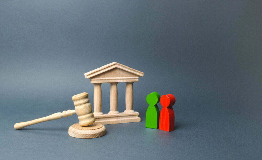 What Are My Chances of Winning an Appeal? 2 40554056 two figures of people opponents stand near the courthouse and the judges gavel the judicial system conflict resolution in court claimant and respondent court case settling disputes