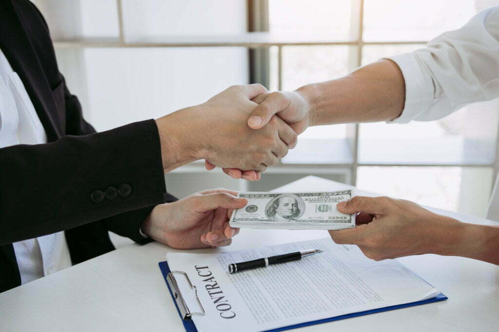 Wouldn’t I Get More Money if I Did Not Hire an Attorney? 2 corporate businessmen shaking hands while one man 2022 12 16 03 44 10 utc