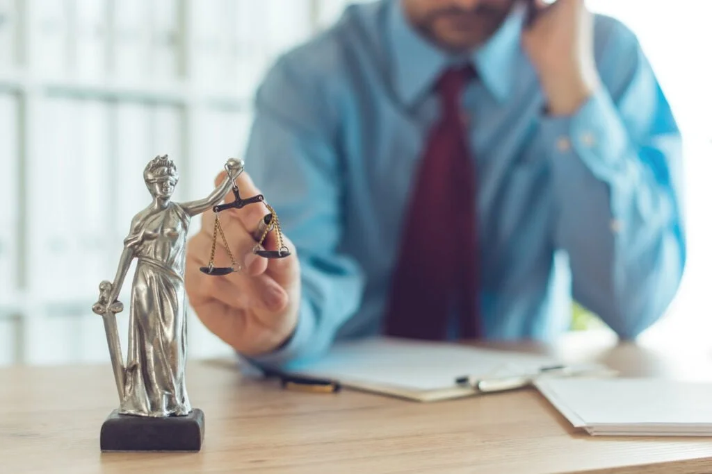 So, You’ve Been Hurt at Work. Now What? 3 attorney talking on mobile device and playing with 2021 08 26 23 03 10 utc