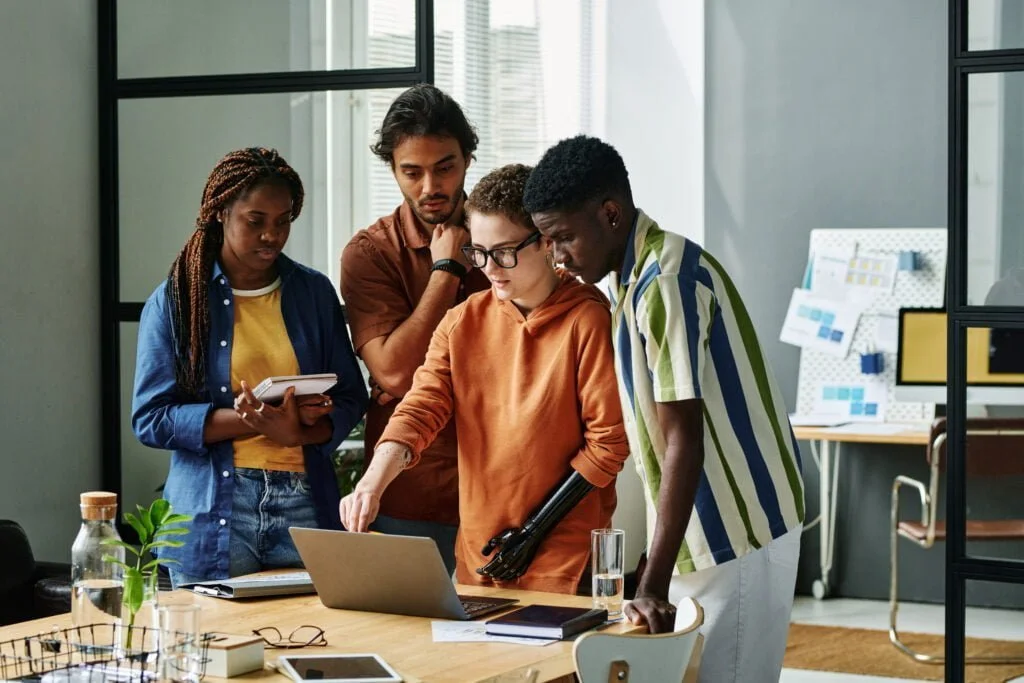 NC Partial Disability Benefits: Could You Be Leaving Money On The Table? 3 young confident designer with partial arm pointing 2022 11 12 14 55 11 utc